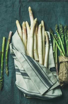Fresh green and white asparagus in towel over dark grey linen table cloth background Fresh green and white asparagus in towel over dark grey linen table cloth background, top view Copyright: xAnnaxIvanovax AI200417-20