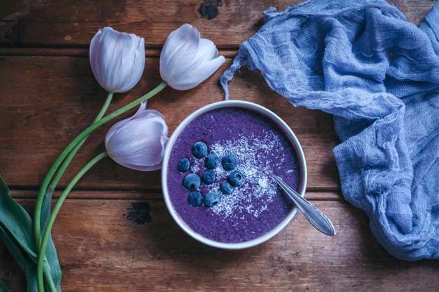 Blueberry smoothie bowl on a rustic wooden table Blueberry smoothie bowl on a rustic wooden table Copyright: xLilixBasicxCapaccettixPhotographyx LBC070417-3