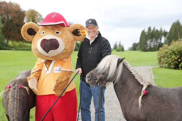 28 Tabaluga Golf Cup Michael Roll, the organizer of the Tabaluga Golf Cup together with Bollie Bear , the mascot of the Tabaluga Foundation and a pony, Tutzing Bavaria Germany Golf Course Tutzing