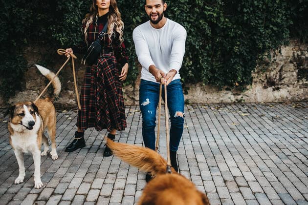 young attractive couple walking their dogs on a leash in the streets of Barcelona, Spain, Model released JakeJakab_BarcelonaWithTbendina_36 Copyright: xJakexJakabx MR