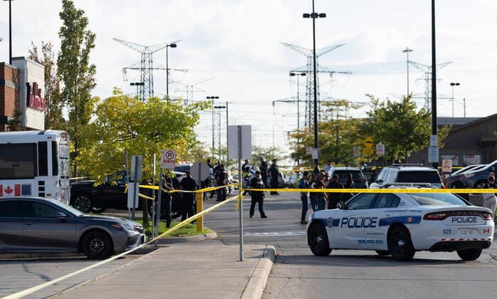September 12, 2022, Mississauga, ON, CANADA: Police vehicles and officers are seen behind tape at a scene in Mississauga, Ont., Monday, Sept. 12, 2022. A Toronto police officer has been fatally shot and a suspect is in custody after two separate shootings left two dead and three injured in the Greater Toronto Area on Monday afternoon. Mississauga CANADA  - ZUMAc35_ 20220912_zaf_c35_110 Copyright: xArlynxMcadoreyx