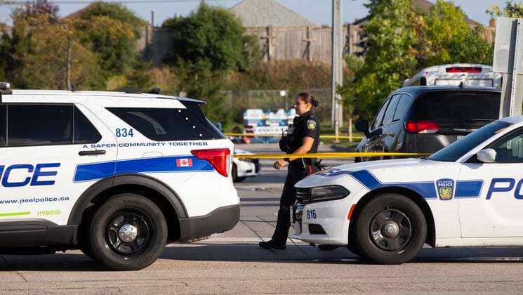 (220913) -- MISSISSAUGA, Sept. 13, 2022 -- A police officer on duty is seen at the scene of double shootings in Mississauga, the Greater Toronto Area, Canada, Sept. 12, 2022. A Canadian police officer was killed on Monday and a suspect is in custody following two daylight shootings in Toronto, the largest city in the country, local media reported. (Photo by Xinhua) CANADA-MISSISSAUGA-SHOOTING ZouxZheng 