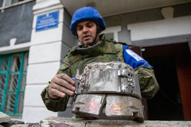 LUGANSK PEOPLE S REPUBLIC - SEPTEMBER 14, 2022: An officer of the LPR representative office in the Joint Centre for Control and Coordination on ceasefire shows shell fragments discovered at a college building damaged in a shelling attack in Perevalsk. The Ukrainian Armed Forces fired six HIMARS missiles at the city on September 14, a 15-year-old student dead, another seven people injured. The Russian Armed Forces are carrying out a special military operation in Ukraine in response to requests from the leaders of the Donetsk People s Republic and Lugansk People s Republic for assistance. Alexander Reka TASS  TS142576