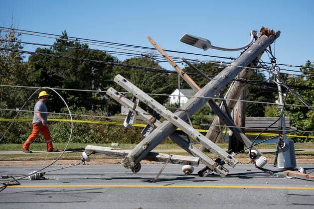 September 25, 2022, Halifax, NS, Canada: A worker walks past a downed power pole caused by post-tropical storm Fiona in Dartmouth, N.S. on Sunday, September 25, 2022. Halifax Canada  - ZUMAc35_ 20220925_zaf_c35_040 Copyright: xDarrenxCalabresex