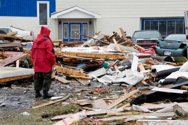 September 26, 2022, Port aux Basques, NL, CANADA: A Canadian Forces Ranger examines damage to a home in Port aux Basques, N.L., Monday, Sept. 26, 2022. Across the Maritimes, eastern Quebec and in southwestern Newfoundland, the economic impact of hurricane Fiona™s wrath is still being tallied. Port aux Basques CANADA  - ZUMAc35_ 20220926_zaf_c35_129 Copyright: xFrankxGunnx