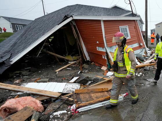 September 26, 2022, Port aux Basques, NL, CANADA: A firefighter examines damage to a home in Port aux Basques, N.L., Monday, Sept. 26, 2022. Across the Maritimes, eastern Quebec and in southwestern Newfoundland, the economic impact of hurricane Fiona™s wrath is still being tallied. Port aux Basques CANADA  - ZUMAc35_ 20220926_zaf_c35_134 Copyright: xFrankxGunnx