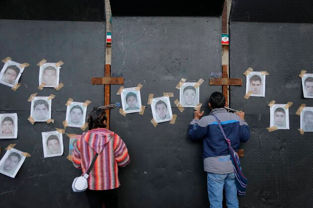 September 26, 2022, Mexico, Mexico: Protesters look through the fences during a demonstration to commemorate the 8th anniversary of the disappearance of the 43 Ayotzinapa students. On the night of September 26, 2014, 43 students from the Raoel Isidro Burgos Rural Normal School located in Iguala, Guerrero, were victims of forced disappearance by members of public security from the state of Guerrero and federal military security..The students had allegedly tried to hijack trucks to use for their protests. Mexico Mexico - ZUMAs197 20220926_zaa_s197_331 Copyright: xGuillermoxDiazx