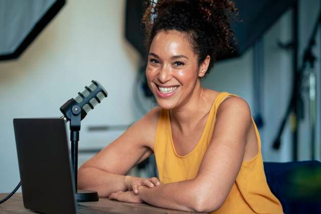 Cheerful radio presenter with microphone in studio model released, Symbolfoto property released, JOSEF13114