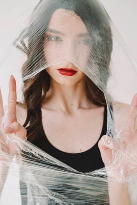 Young woman breaking hole through plastic model released, Symbolfoto, ORF00028