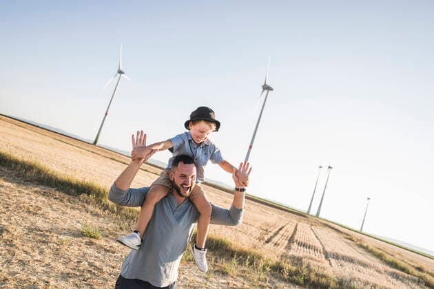Father carrying son on shoulders in front of wind turbines model released, Symbolfoto property released, UUF27128