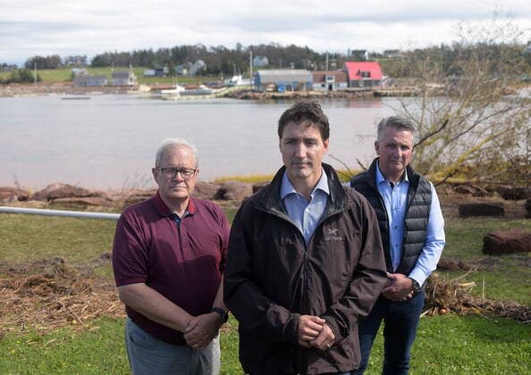September 27, 2022, Stanley Bridge, PEI, Canada: Prime Minister Justin Trudeau speaks to reporters as he visits Stanley Bridge, P.E.I., to see the damage done by post-tropical storm Fiona, on Tuesday, Sept. 27, 2022. At left is Veterans Affairs Minister Lawrence MacAulay, at right, Liberal MP for Malpeque Heath MacDonald. Stanley Bridge Canada  - ZUMAc35_ 20220927_zaf_c35_084 Copyright: xBrianxMcinnisx