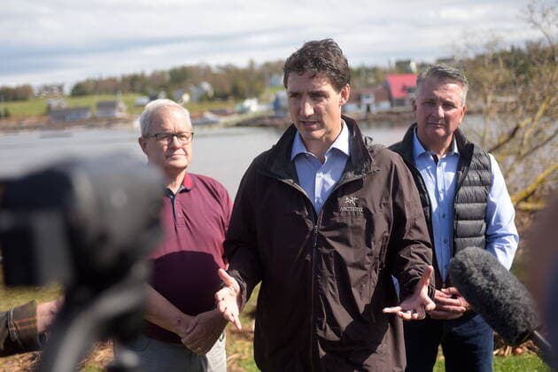 September 27, 2022, Stanley Bridge, PEI, Canada: Prime Minister Justin Trudeau speaks to reporters as he visits Stanley Bridge, P.E.I., to see the damage done by post-tropical storm Fiona, on Tuesday, Sept. 27, 2022. At left is Veterans Affairs Minister Lawrence MacAulay, at right, Liberal MP for Malpeque Heath MacDonald. Stanley Bridge Canada  - ZUMAc35_ 20220927_zaf_c35_085 Copyright: xBrianxMcinnisx