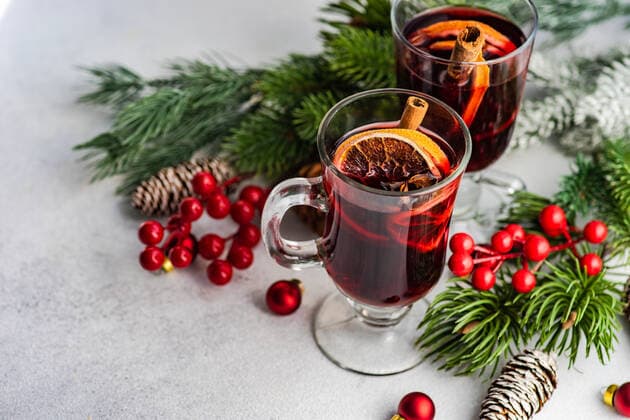 Mulled wine with spices with holiday decoration on white concrete background AnnaBogush_ID867_31932_002 Copyright: xAnnaxBogushx Model Released