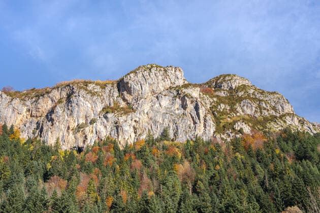From below sunlit rough mountains and green forest located against cloudless blue sky on summer day in Ordesa y Monte Perdido National Park in Spain JuanLopez_ID709_25756_011 Copyright: xJuanxLopezx Model Released
