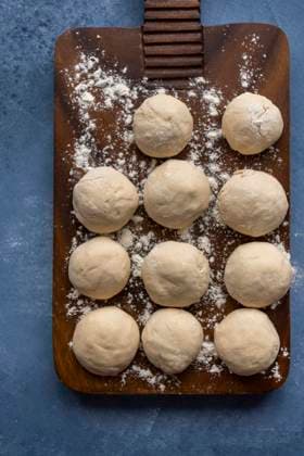 Turkish lahmacun dough balls on a wooden board slightly dusted with flour. Copyright: xYusufxRizaxGunaydinx YG100720-5