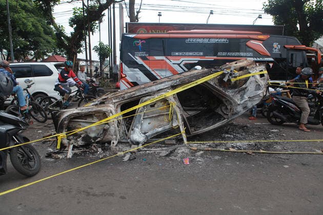 (221002) -- MALANG, Oct. 2, 2022 -- Photo taken on Oct. 2, 2022 shows the wreckage of a burned car outside the Kanjuruhan Stadium in Malang of East Java province, Indonesia. At least 129 people were killed and 180 others injured after a stampede and clashes at a football match in Indonesia s Malang, East Java province on Saturday evening, Indonesian police said on Sunday. Provincial police chief Nico Afinta said at a press conference that the chaos happened on late Saturday at the Kanjuruhan Stadium in Malang regency right after Arema Malang club lost to Persebaya Surabaya in the Indonesian Liga 1 football contest. (Photo by Xinhua) INDONESIA-MALANG-FOOTBALL MATCH-STAMPEDE-CLASH-CASUALTIES BayuxNovanta 