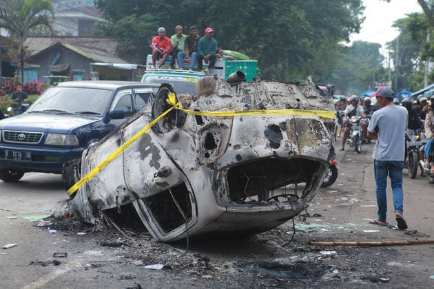 (221002) -- MALANG, Oct. 2, 2022 -- Photo taken on Oct. 2, 2022 shows the wreckage of a burned car outside the Kanjuruhan Stadium in Malang of East Java province, Indonesia. At least 129 people were killed and 180 others injured after a stampede and clashes at a football match in Indonesia s Malang, East Java province on Saturday evening, Indonesian police said on Sunday. Provincial police chief Nico Afinta said at a press conference that the chaos happened on late Saturday at the Kanjuruhan Stadium in Malang regency right after Arema Malang club lost to Persebaya Surabaya in the Indonesian Liga 1 football contest. (Photo by Xinhua) INDONESIA-MALANG-FOOTBALL MATCH-STAMPEDE-CLASH-CASUALTIES BayuxNovanta 