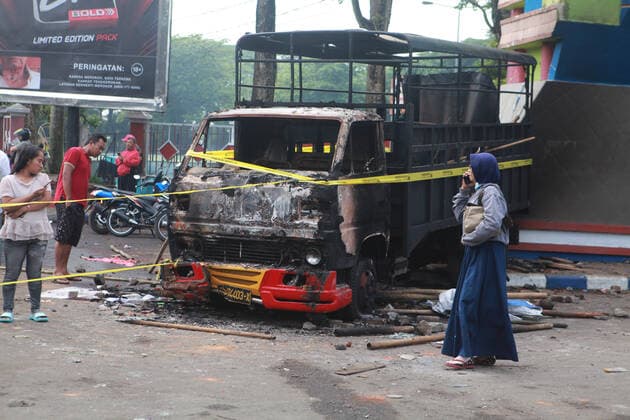 (221002) -- MALANG, Oct. 2, 2022 -- Photo taken on Oct. 2, 2022 shows the wreckage of a burned truck outside the Kanjuruhan Stadium in Malang of East Java province, Indonesia. At least 129 people were killed and 180 others injured after a stampede and clashes at a football match in Indonesia s Malang, East Java province on Saturday evening, Indonesian police said on Sunday. Provincial police chief Nico Afinta said at a press conference that the chaos happened on late Saturday at the Kanjuruhan Stadium in Malang regency right after Arema Malang club lost to Persebaya Surabaya in the Indonesian Liga 1 football contest. (Photo by Xinhua) INDONESIA-MALANG-FOOTBALL MATCH-STAMPEDE-CLASH-CASUALTIES BayuxNovanta 