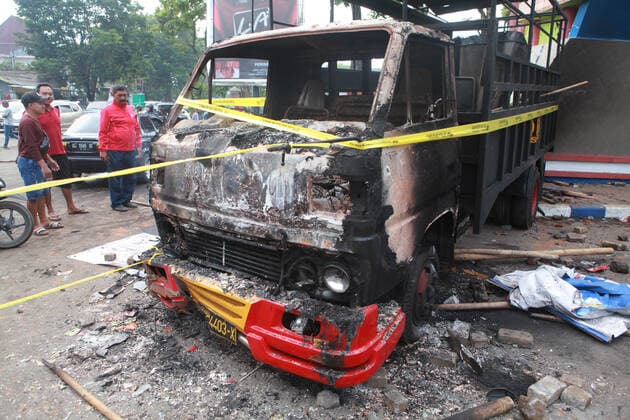 (221002) -- MALANG, Oct. 2, 2022 -- Photo taken on Oct. 2, 2022 shows the wreckage of a burned truck outside the Kanjuruhan Stadium in Malang of East Java province, Indonesia. At least 129 people were killed and 180 others injured after a stampede and clashes at a football match in Indonesia s Malang, East Java province on Saturday evening, Indonesian police said on Sunday. Provincial police chief Nico Afinta said at a press conference that the chaos happened on late Saturday at the Kanjuruhan Stadium in Malang regency right after Arema Malang club lost to Persebaya Surabaya in the Indonesian Liga 1 football contest. (Photo by Xinhua) INDONESIA-MALANG-FOOTBALL MATCH-STAMPEDE-CLASH-CASUALTIES BayuxNovanta 