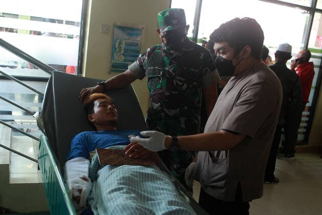 (221002) -- MALANG, Oct. 2, 2022 -- An injured man receives medical treatment at a hospital in Malang of East Java province, Indonesia, Oct. 2, 2022. The death toll in a crowd stampede at a football match in Indonesia s East Java province has reached 174 as of Sunday afternoon, according to the province s deputy governor Emil Dardak. The tragedy occurred on Saturday night at the Kanjuruhan Stadium in Malang of Indonesia s East Java province, right after Arema Malang club lost to Persebaya Surabaya in an Indonesian league football match. (Photo by Xinhua) INDONESIA-MALANG-FOOTBALL MATCH-STAMPEDE BayuxNovanta 