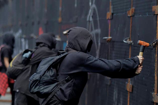 54th Anniversary Of The Tlatelolco Massacre In Mexico City A member of the Black Bloc hits a metal fence outside the National Palace while demonstrators protest in the Zocalo in Mexico City, on the occasion of the 54th anniversary of the Tlatelolco Massacre that took place on 2 October 1968 in the square. Mexico City Mexico City Mexico  Copyright: xGerardoxVieyrax originalFilename: vieyra-notitle221002_npNf5.jpg