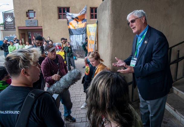 October 3, 2022, USA: Rep. Larry Scott, R-Hobbs, right, talks with protesters blocking the entrance to the Eldorado Hotel, in Santa Fe, where the New Mexico Oil and Gas Association is gathering. There are around 50 protesters, organized by YUCCA (Youth United for Climate Crisis Acrtion), protesting against oil and gas exstraction in New Mexico. USA - ZUMAab1_ 20221003_zaf_ab1_011 Copyright: xEddiexMoorex