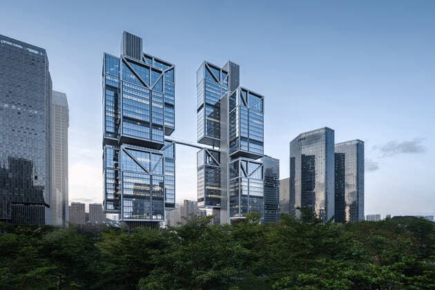 **VIDEO AVAILABLE: CONTACT INFO@COVERMG.COM TO RECEIVE** British architecture studio Foster + Partners has completed two skyscrapers - connected by an open-air suspension bridge, 105 meters above the ground - for Chinese drone manufacturer DJI in Shenzhen called DJI Sky City. DJI Sky City in Shenzen is comprised of the two 200-metre-high skyscrapers that now house the the robotics company and drone specialists DJI. The bridge is attached to each of the towers by vertically slatted cores, which both support a series of steel truss-encased, glass volumes that were stacked and cantilevered on top of one another. Its ground floor houses public facilities, including a community healthcare centre, and lobbies that each contain an indoor zen g Copyright: xx 52040741 EDITORIAL USE ONLY. NOT FOR USE BY NEWSPAPERS BASED IN THE UK.
