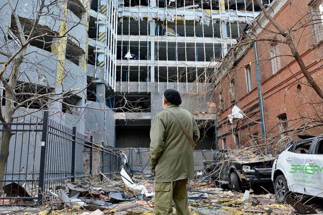 October 13, 2022, Kyiv, Ukraine: A man inspects damaged cars as a result of the Russian missile attack near the 101 Tower office building. After several months of relative calm, multiple explosions rocked Kyiv early on a Monday morning. The head of the Ukrainian military said that Russian forces launched at least 75 missiles in Ukraine, with fatal strikes targeting the capital Kyiv, and cities in the south and west. Kyiv Ukraine - ZUMAs197 20221013_zab_s197_020 Copyright: xAleksandrxGusevx