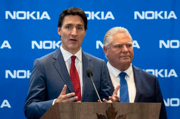 October 17, 2022, Ottawa, ON, Canada: Ontario Premier Doug Ford looks on as Prime Minister Justin Trudeau responds to a question following an announcement at NokiaöÄÃ s headquarters, Monday, October 17, 2022 in Ottawa. Ottawa Canada  - ZUMAc35_ 20221017_zaf_c35_008 Copyright: xAdrianxWyldx