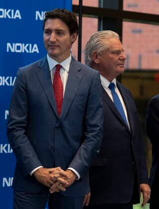 October 17, 2022, Ottawa, ON, Canada: Ontario Premier Doug Ford and Prime Minister Justin Trudeau wait for a question and answer session to begin following an announcement in Ottawa, Monday, Oct. 17, 2022. Ottawa Canada  - ZUMAc35_ 20221017_zaf_c35_016 Copyright: xAdrianxWyldx