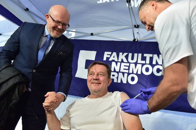 Czech Health Minister Vlastimil Valek (TOP 09), left, gives press conference on COVID-19 vaccination campaign We get vaccinated for life without fear in Brno University Hospital. Czech actor and comedian Petr Ctvrnicek receives COVID-19 vaccination in Brno University Hospital, Czech Republic, October 24, 2022. (CTKxPhoto VaclavxSalek) CTKPhotoP2022102402626  sal 01