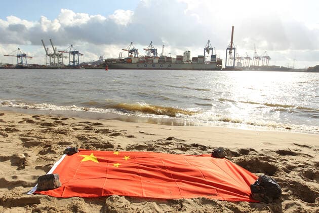News Themen der Woche KW43 News Bilder des Tages Eine Flagge der Volksrepublik China liegt im Sand vom Elbstrand Övelgönne. Im Hintergrund wird die Ladung eines Containerschiffes der Reederei COSCO Shipping in einem Containertermial der Hamburger Hafen und Logistik AG gelöscht. Die chinesischen Staatsreederei will sich am Container-Terminal Tollerort der HHLA beteiligen. Darum ist ein Streit entbrannt. Medienberichten zufolge soll Cosco statt der geplanten 35 Prozent nun nur 24,9 Prozent der Anteile übernehmen dürfen. Altona Hamburg *** A flag of the Peoples Republic of China lies in the sand of Övelgönne beach on the Elbe In the background, the cargo of a container ship belonging to the shipping company COSCO Shipping is being unloaded in a container terminal belonging to Hamburge