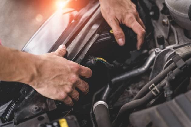 October 16, 2022: Hobby car mechanic at work and repair on a headlight. Installation of a new light in a motor vehicle. Amateur workshop *** Hobby Automechaniker bei der Arbeit und Reparatur an einem Scheinwerfer. Einbau eines neuen Licht in ein Kfz. Amateur Werkstatt