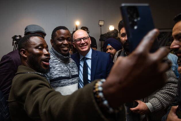 October 26, 2022, Winnipeg, MB, Canada: Ayodele Odeyemi, left, and supporters take a selfie with Scott Gillingham as people celebrate in Winnipeg, on Wednesday, October 26, 2022, following Gillingham™s win in the city™s mayoral election. Winnipeg Canada  - ZUMAc35_ 20221026_zaf_c35_164 Copyright: xDanielxCrumpx
