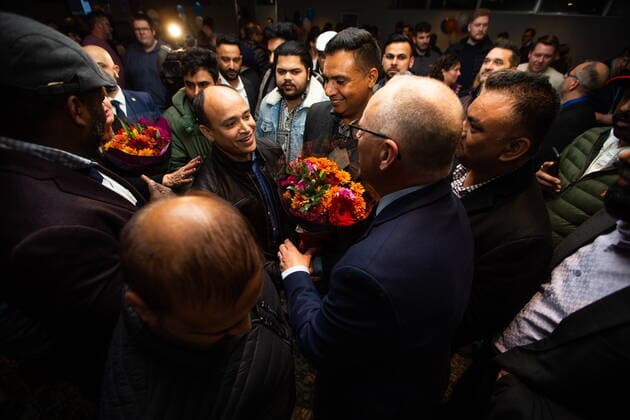 October 26, 2022, Winnipeg, MB, Canada: Sharif Islam, president of the Canada-Bangladesh Association, presents Scott Gillingham with flowers following Gillingham™s mayoral election win in Winnipeg, on Wednesday, October 26, 2022. Winnipeg Canada  - ZUMAc35_ 20221026_zaf_c35_166 Copyright: xDanielxCrumpx