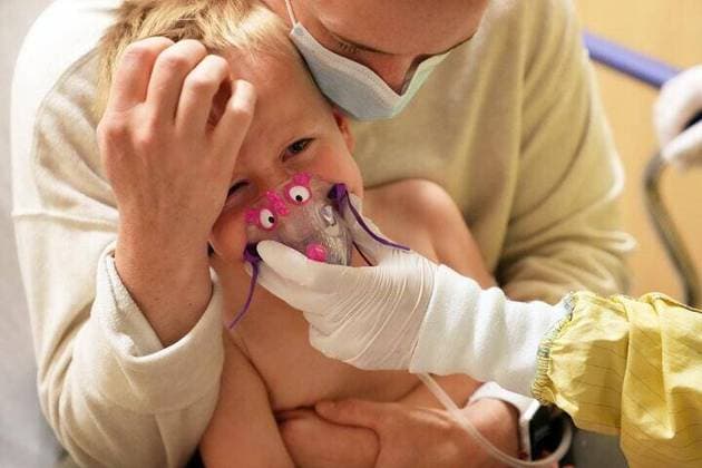 September 27, 2021: In this file photo, Meredith Legree of Lakeville, Minnesota, holds her frightened son Andrew, 3, as respiratory therapist Sirena Ortega holds a mask to his face for a nebulizer treatment to help decrease inflammation in his airway and allow him to breathe easier as they waited for the results of his RSV test at ChildrenÃ¢â‚¬â ¢s Hospital of St. Paul. - ZUMAm67_ 20210927_zaf_m67_075 Copyright: xTNSx