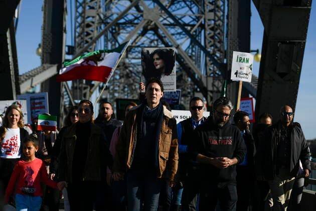October 29, 2022, Ottawa, ON, CAN: Canadian Prime Minister Justin Trudeau, centre, walks with demonstrators as they cross the Alexandra Bridge in Ottawa on Saturday, Oct. 29, 2022. Scores of demonstrators lined the streets of several major Canadian cities Saturday as part of a worldwide human chain organized by the Association of Families of Flight PS752 Victims in solidarity with antigovernment protesters in Iran. Ottawa CAN  - ZUMAc35_ 20221029_zaf_c35_070 Copyright: xJustinxTangx