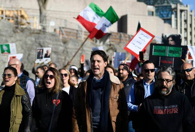 October 29, 2022, Ottawa, ON, CAN: Canadian Prime Minister Justin Trudeau, centre, chants as he walks with demonstrators preparing to cross the Alexandra Bridge in Ottawa on Saturday, Oct. 29, 2022. Scores of demonstrators lined the streets of several major Canadian cities Saturday as part of a worldwide human chain organized by the Association of Families of Flight PS752 Victims in solidarity with antigovernment protesters in Iran. Ottawa CAN  - ZUMAc35_ 20221029_zaf_c35_075 Copyright: xJustinxTangx