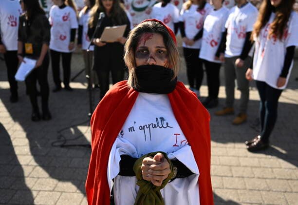 October 29, 2022, Ottawa, ON, CAN: A demonstrator stands with their hands bound, mouth covered and face paint symbolizing abuse faced by women in Iran as they participate in a demonstration in Ottawa on Saturday, Oct. 29, 2022. Scores of demonstrators lined the streets of several major Canadian cities Saturday as part of a worldwide human chain organized by the Association of Families of Flight PS752 Victims in solidarity with antigovernment protesters in Iran. Ottawa CAN  - ZUMAc35_ 20221029_zaf_c35_077 Copyright: xJustinxTangx