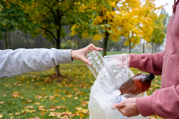 Hands of man holding plastic bag and boy putting bottle in it model released, Symbolfoto, EYAF02197