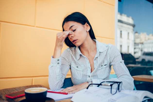 Stressed businesswoman with eyes closed sitting at table in sidewalk cafe model released, Symbolfoto, OYF00780