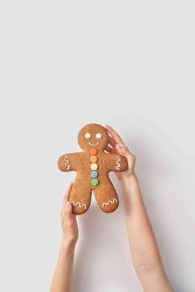 Woman holding gingerbread man cookie on white background model released, Symbolfoto, YDF00004