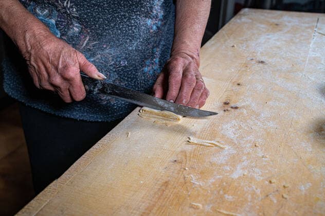 RECORD DATE NOT STATED the grandmother prepares homemade egg pasta noodles , 35858258.jpg, grandmother, homemade, kitchen, home, pasta, recipe, woman, adult, prepare, baker, bakery, countryside, dough, preparation, cooking, agriculture, baking, bread, knead, oven, pastry, rural rustic, senor, wrinkles, bake, cake, housework, kneading, closeup, female, food, labor, meal, restaurant, action, eat, eating, elderly, female hand, flour food, human person, ingredient, italian cuisine, mom mother, old older, pie pizza, preparing, profession, restaurant cafe menu, senior