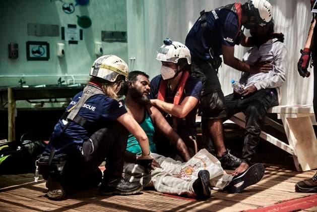 Two survivors in a state of shock are assisted by members of SOS Mediterranee on board the Ocean Viking, during the rescue operation of a distressed boat containing 71 people.  AntoninxBuratx xLexPictorium LePictorium_0270062