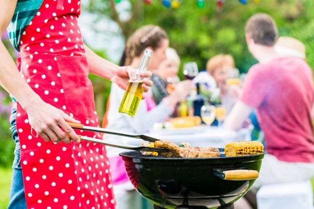 RECORD DATE NOT STATED Yong man at the bbq grill turning the meat, in the background friends are having garden party, model released, , 36338600.jpg, Family, barbecue, garden, bbq, barbeque, meadow, mother, woman, man, father, child, children, kids, boy, girl, mom, dad, neighbors, friends, grandparents, couple, grandmother, group, party, garden party, food, drink, drinking, meat, sausages, steaks, corn, vegetables, beer, spring, summer, sitting, together, outdoor, people, Caucasian, generations, young, old