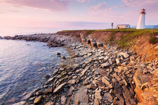 RECORD DATE NOT STATED Enragee Point Lighthouse in Nova Scotia at sunset. Nova Scotia, Canada. , 36638162.jpg, Atlantic, Canada, Cape Breton, Cape Breton Highlands National Park, Enragee Point Lighthouse, National Park, Nova Scotia, beach, building, day, landmark, landscape, light, lighthouse, ocean, outdoors, sea, sunny, travel, white, sunset, shore, stone, rock