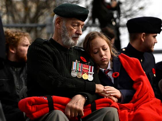 November 11, 2022, Ottawa, ON, CAN: Mason Johnson, 13, holds the hand of his grandfather, veteran David Haase, who served as a military engineer in the Canadian Forces, during the National Remembrance Day Ceremony at the National War Memorial in Ottawa, on Friday, Nov. 11, 2022. Ottawa CAN - ZUMAc35_ 20221111_zaf_c35_047 Copyright: xJustinxTangx