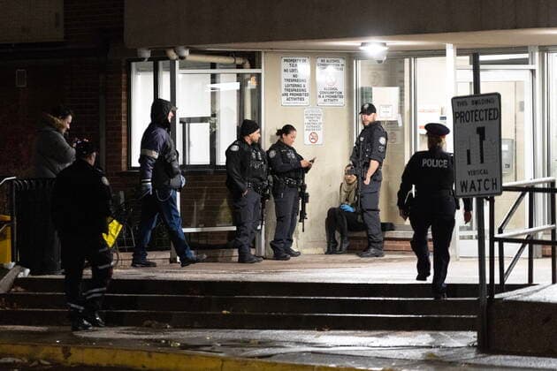 November 15, 2022, TORONTO, ON, CANADA: Police guard the entrance to the lobby of 245 Dunn Ave, the scene of a quadruple shooting in Toronto, Tuesday, Nov. 15, 2022. Police say one person is dead and three others have been injured after shots rang out in an apartment building on Dunn Ave near Queen St West. TORONTO CANADA  - ZUMAc35_ 20221115_zaf_c35_193 Copyright: xArlynxMcadoreyx