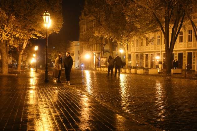 November 16, 2022, Odesa, Ukraine: A young couple is seen standing under a street lamp on Deribasovskaya Street. The usually brightly lit main street of the city looks somewhat different due to blackouts. On November 15, 2022, the Russian military carried out another massive attack on Ukraine s critical infrastructure which in terms of the number of missiles fired - about 100 units, surpassed the attack on October 10 with 84 missiles and became the largest since the beginning of the war. Energy Minister German Galushchenko believes that this attack may have an impact not only on the energy system of Ukraine, but also on the energy systems of some neighboring countries..Through rocket fire from the side of the Russian Federation, behind the - ZUMAs197 20221116_zaa_s197_434 Copyright: xViacheslavxOnyshchenkox