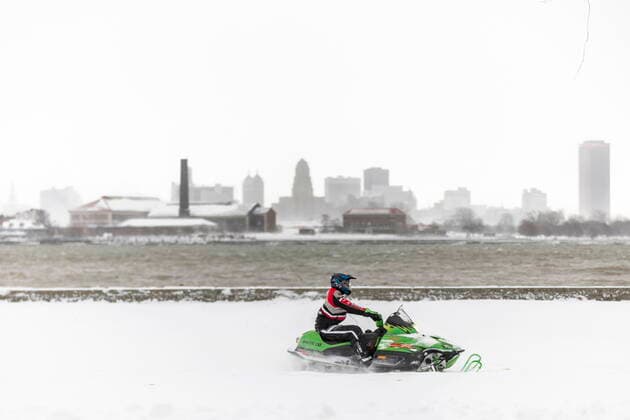 November 19, 2022, Fort Erie, ON, Canada: A snowmobiler rides in Fort Erie, Ont., in front of the Buffalo, N.Y. skyline, during an early winter storm that delivered high winds and large amounts of snow across southern Ontario and western New York, Saturday, Nov. 19, 2022. Fort Erie Canada - ZUMAc35_ 20221119_zaf_c35_116 Copyright: xNickxIwanyshynx